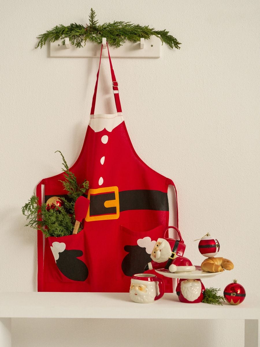 Fartuch kuchenny z motywem Świętego Mikołaja - czerwony - SINSAY