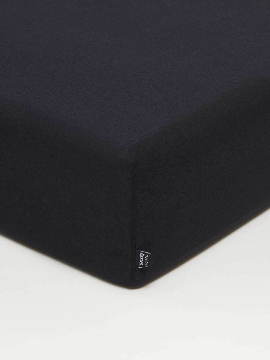 Bavlnené jersey posteľné prestieradlo s elastickou gumou - čierna - SINSAY