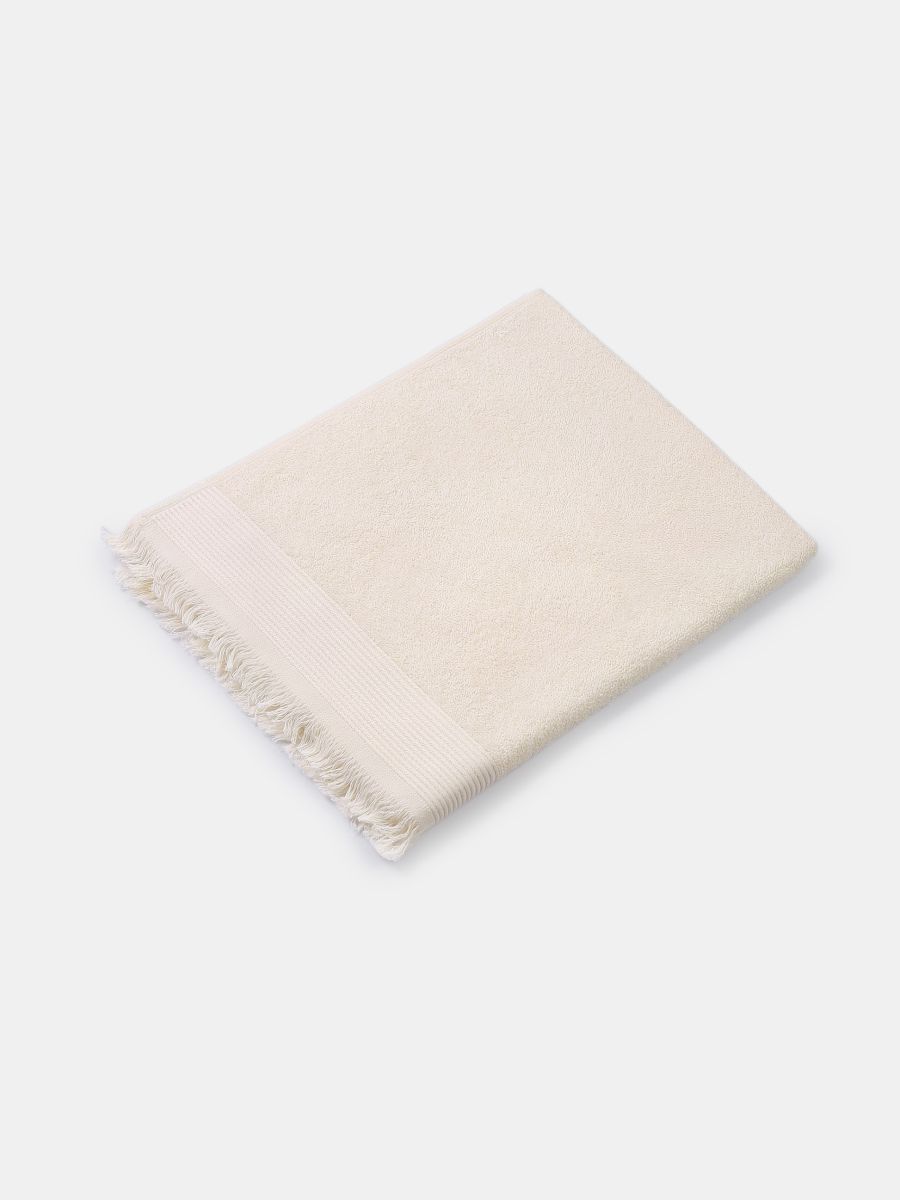 Bawełniany ręcznik z frędzlami - kremowy - SINSAY