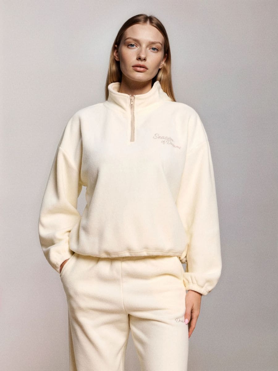 Flis pulover s kratko zadrgo in nastavljivim spodnjim robom s stoperj - krema - SINSAY