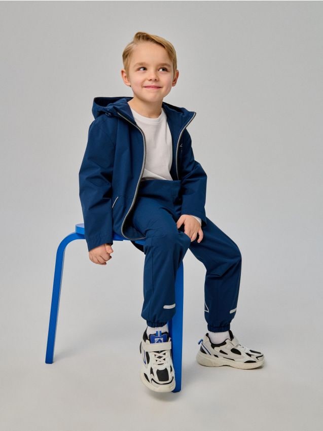 Sinsay - Pantaloni jogger cu imprimeu reflectorizant și finisaj rezistent la apă Active - bleumarin