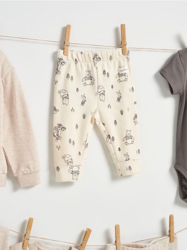 Sinsay - Nohavice s flísovou podšívkou Winnie the Pooh - krémová