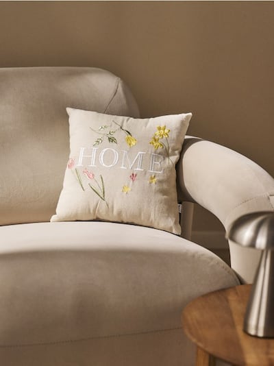 Ukrasna jastučnica sa izvezenim cvetovima i natpisom