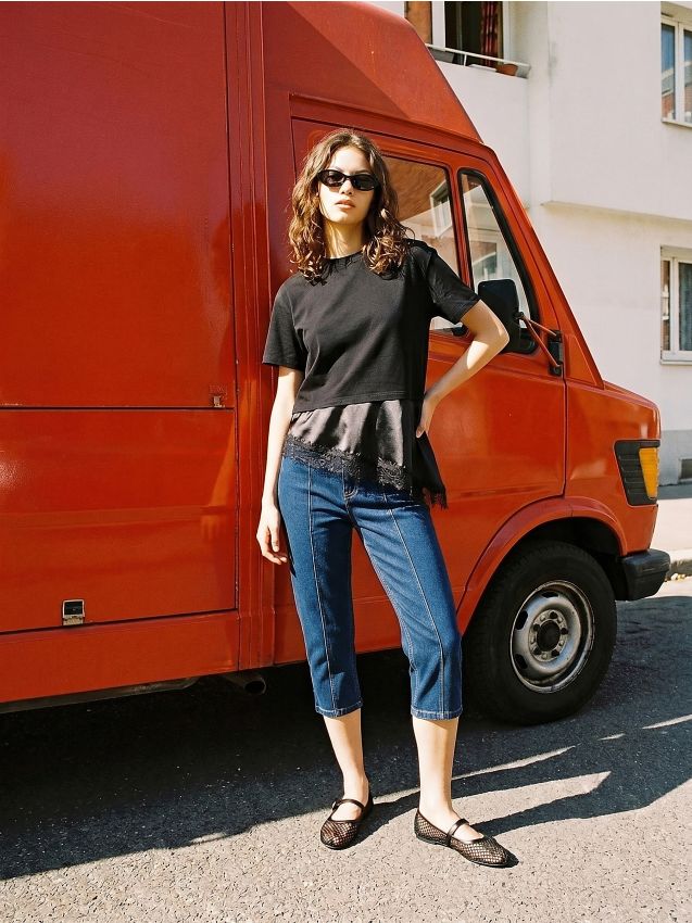 Blusa in cotone con orlo asimmetrico e pizzo decorativo - nero