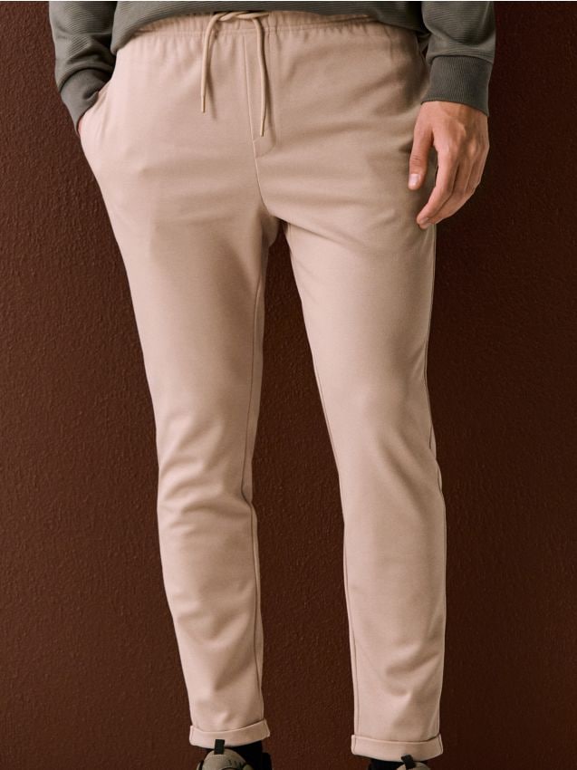 Sinsay - Spodnie dresowe jogger z domieszką wiskozy - beżowy