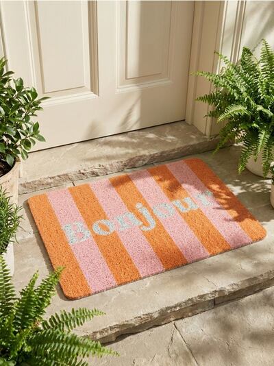 Triibuline uksematt kirjaga Bonjour