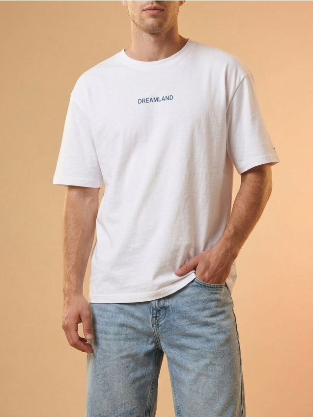 T-shirt in cotone con scritta Dreamland - bianco