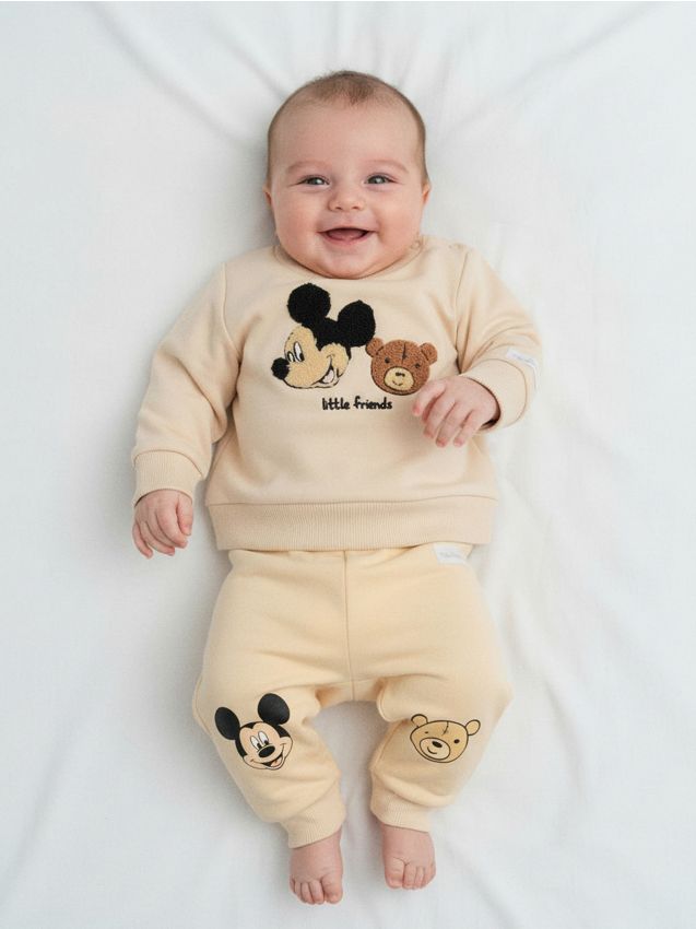 Sinsay - Nohavice s flísovou podšívkou Mickey Mouse - krémová