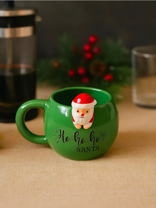 Sinsay - Vianočný keramický hrnček s figúrkou Santy a nápisom - zelená