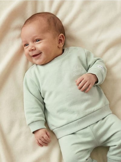 Bombažna jopica z napisom na hrbtu